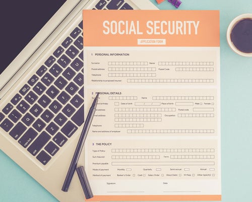 social security document on desk with computer
